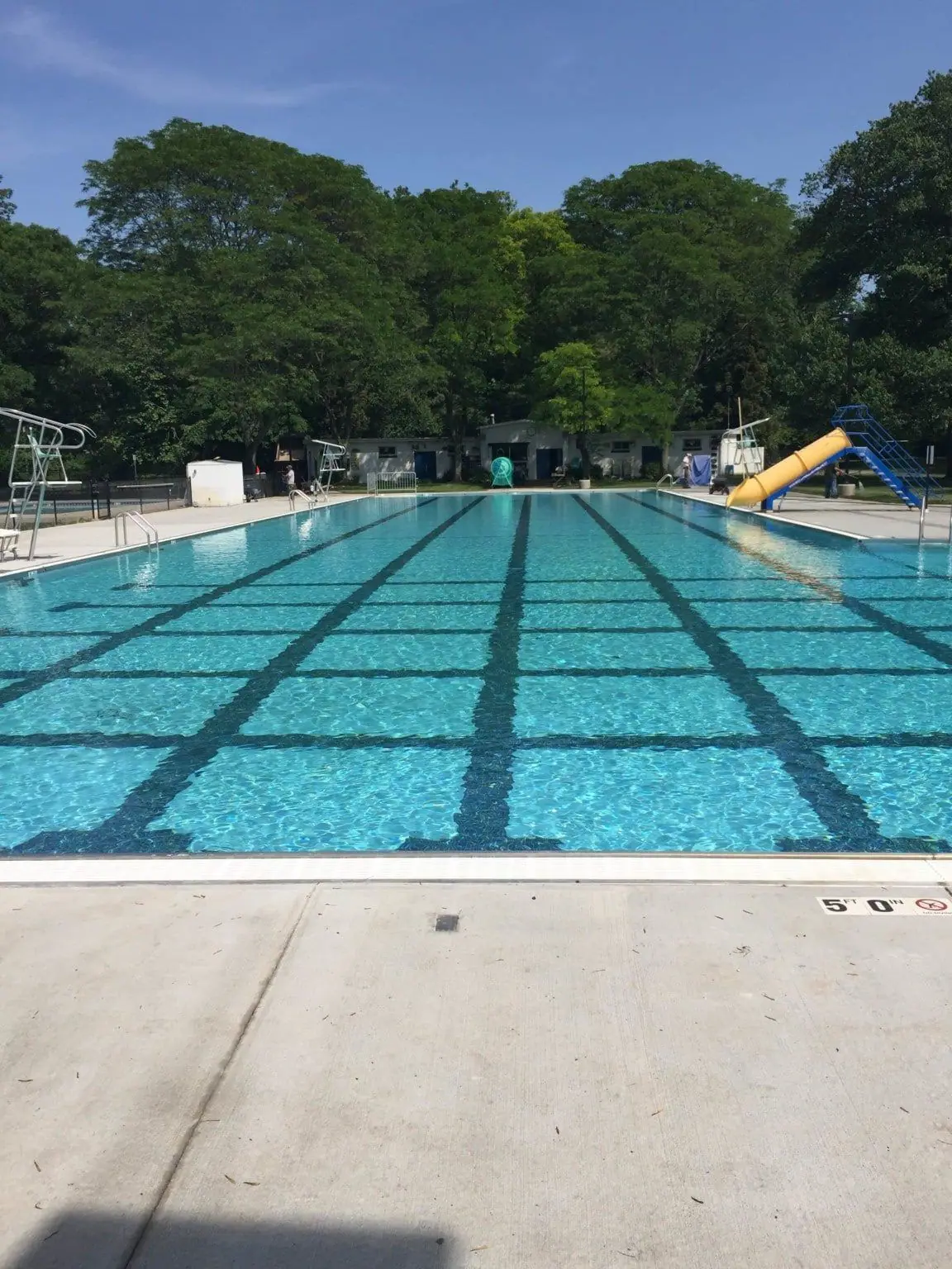 Commercial lap pool with dark lane lines on a white finish
