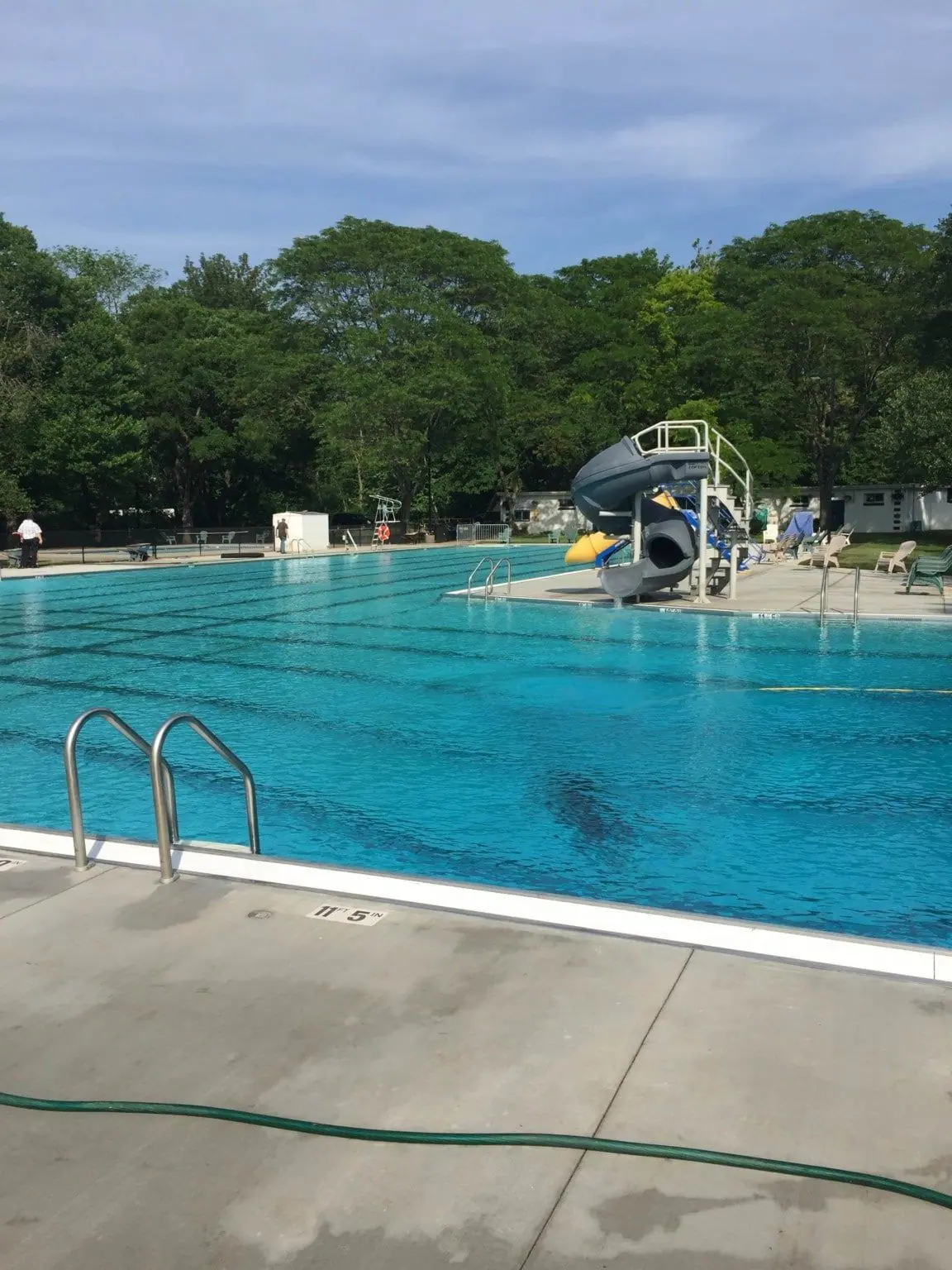Community pool with ladders, deep end and water slide