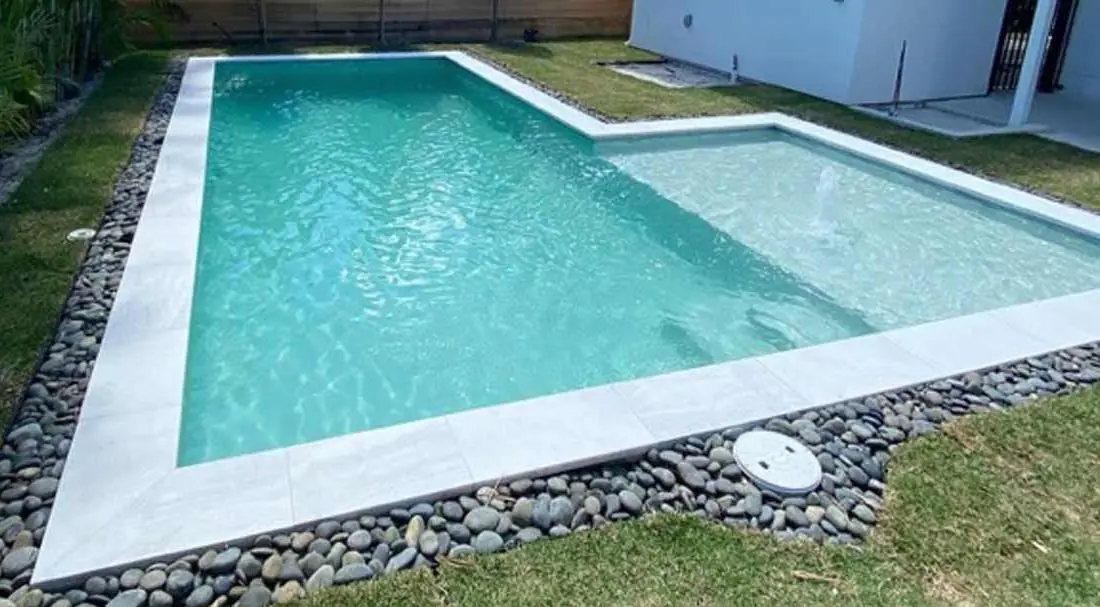 Pool with a Aqua Clear glass-bead finish, geometric pool with paver deck