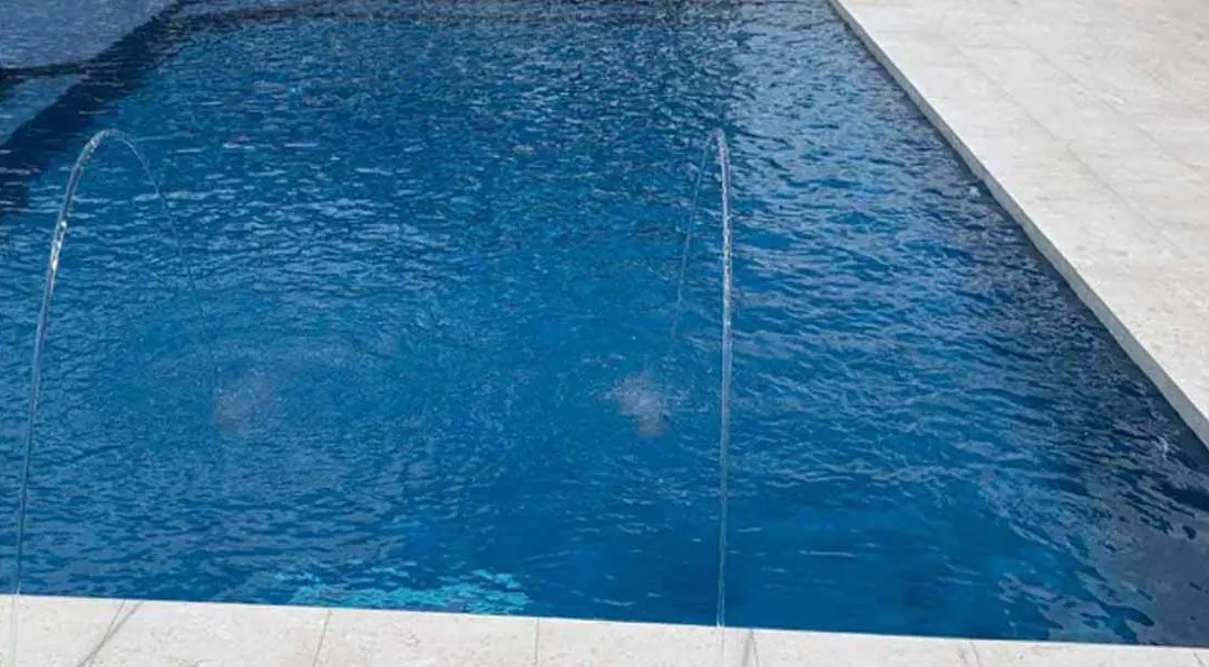 Pool with a Capri glass-bead finish, geometric pool with deck jets
