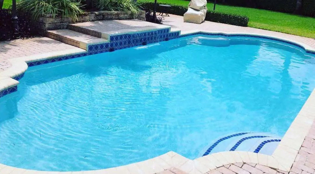 Pool with a Double Sky Blue glass-bead finish, free-form pool with tanning ledge steps