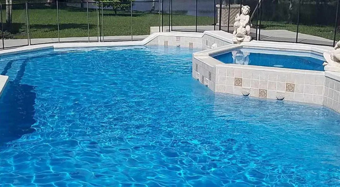 Pool with a Hawaiian glass-bead finish, pool with stone steps and spa spillover