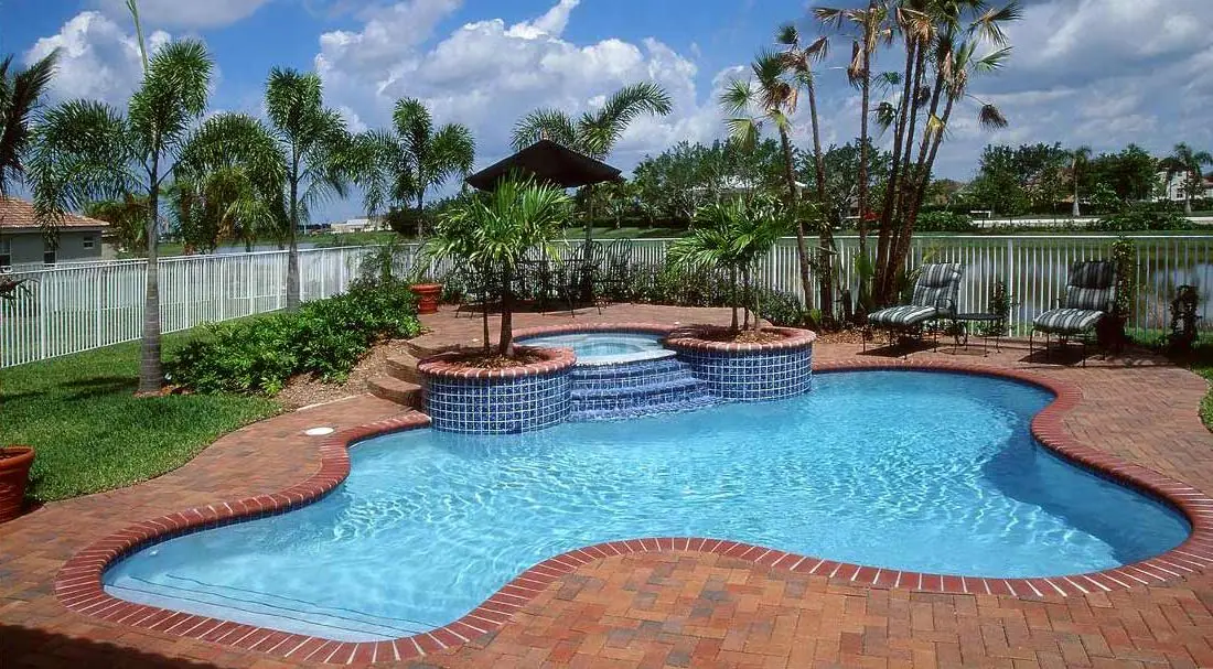 Pool with a Sky Blue glass-bead finish, waterfront pool with brick paver deck
