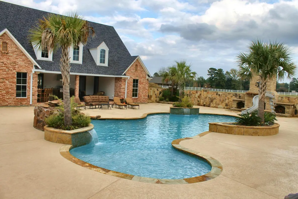 Free-form pool with Super Blue quartz finish and palm trees
