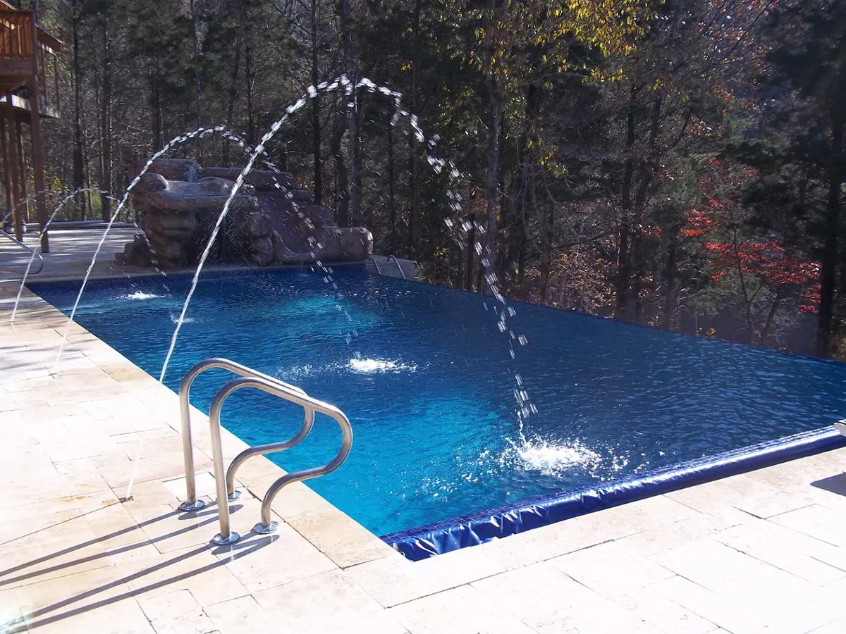 Infinity-edge pool with deck jets and deep Tahoe Blue finish