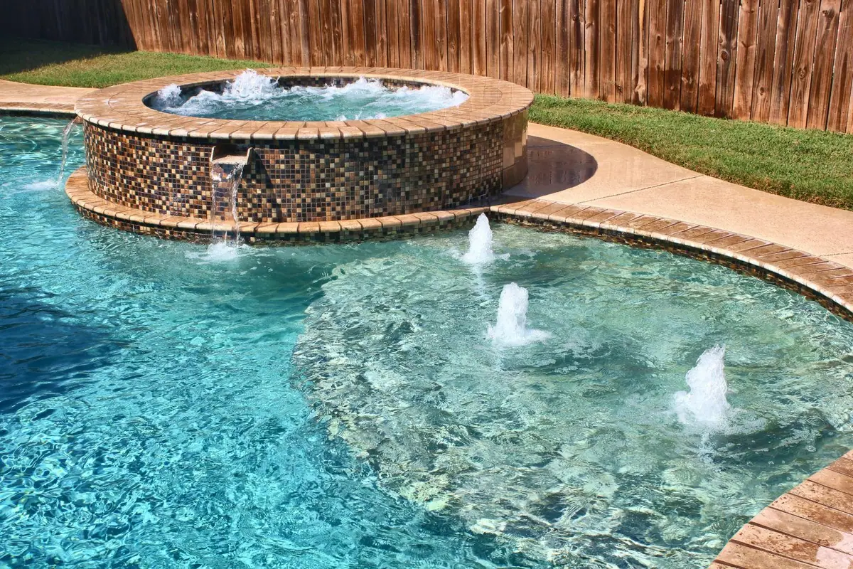 Pool with green-tinted Verde finish and raised spa