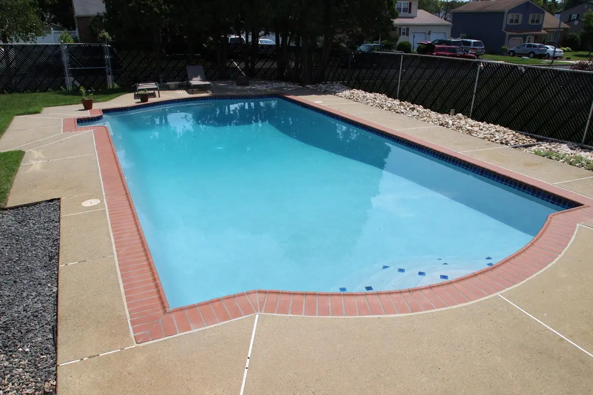 Rectangular pool with smooth white finish, entry steps and brick coping